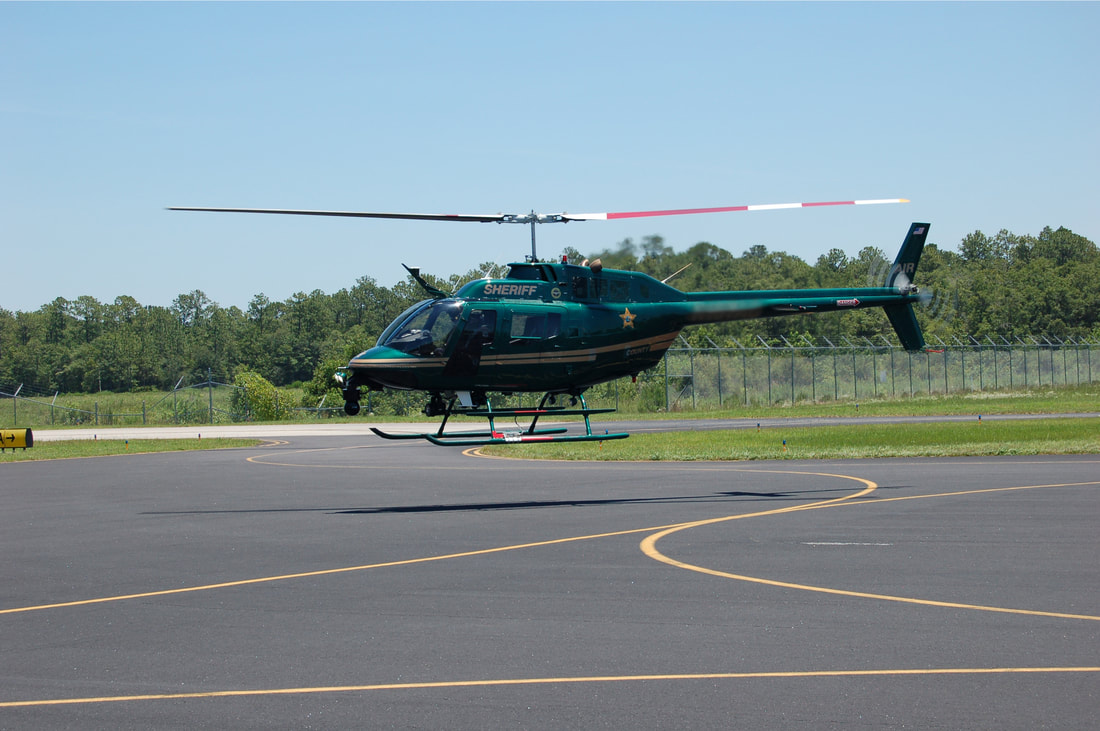 OH-58 in hover during track and balance with DynaVibe and DynaTrack equipment